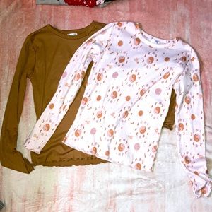 A pink ying-yang shirt that is pair with a brown shirt from the brand yummy soft